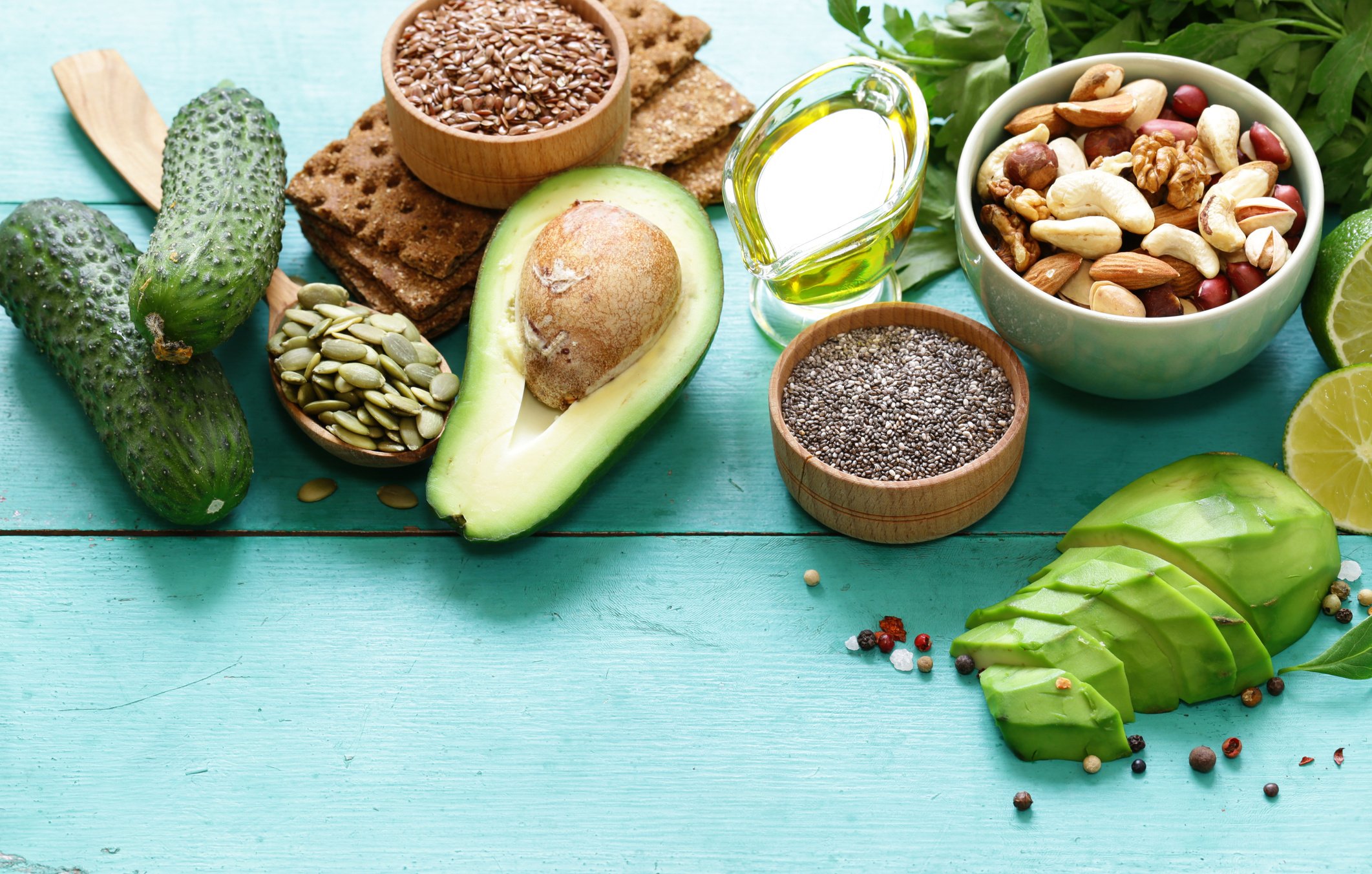 healthy and nutrition food - avocado, chia and flax seeds, olive oil and vegetables